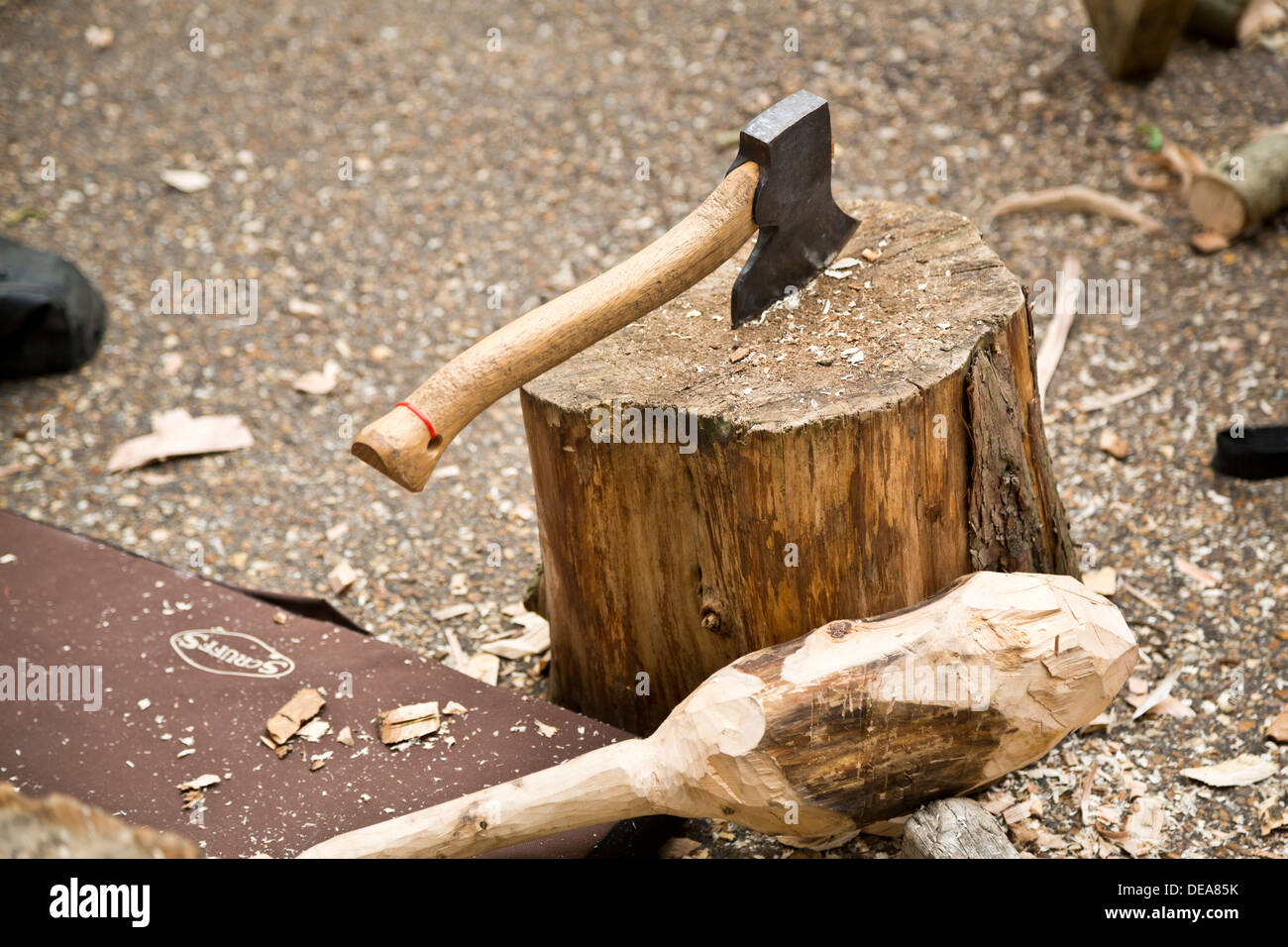 Small axe stuck in chopping log Stock Photo