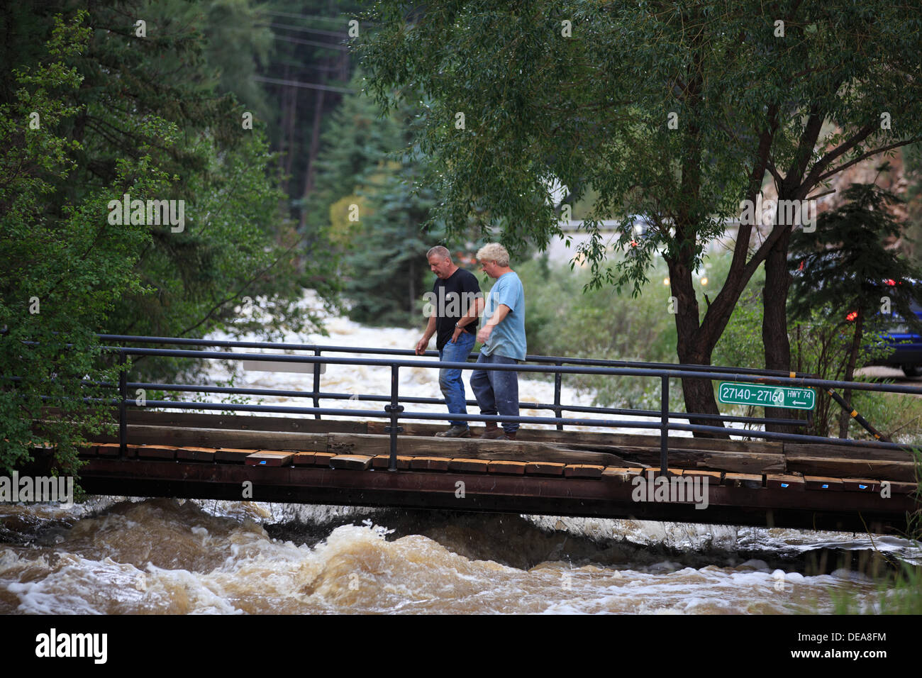 Evergreen, CO USA.  14 Sept, 2013. Residents along Hwy 74 inspect a bridge over Bear Creek to their home amongst the massive flooding  Evergreen is expected to receive more rain through Sunday. © Ed Endicott  Alamy Live News Stock Photo