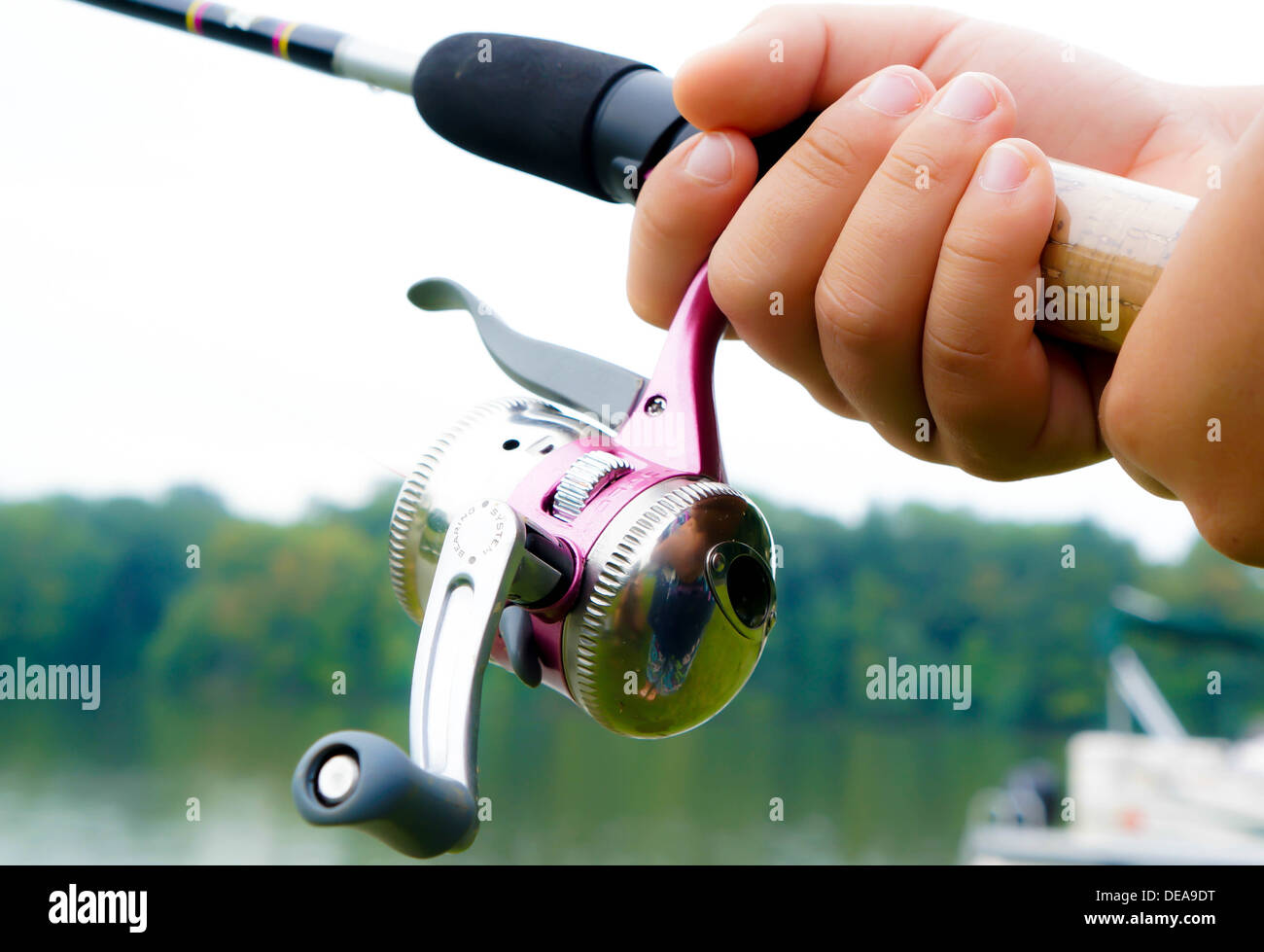 https://c8.alamy.com/comp/DEA9DT/a-childs-hands-holding-a-fishing-pole-near-a-lake-DEA9DT.jpg