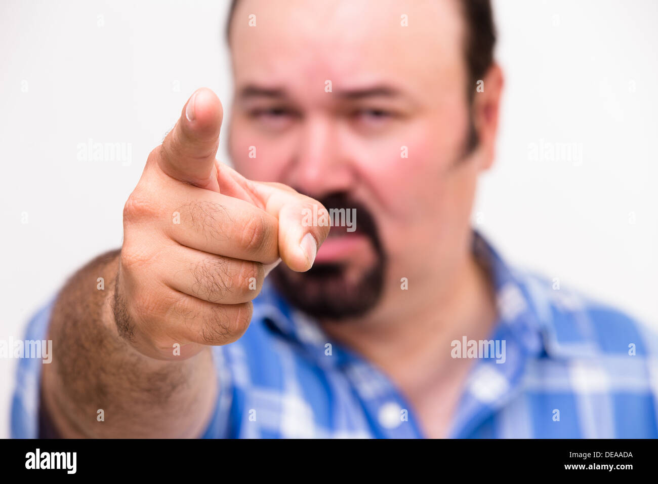 Man pointing an accusatory finger at the camera as he singles out someone to take the blame with selective focus to the hand Stock Photo