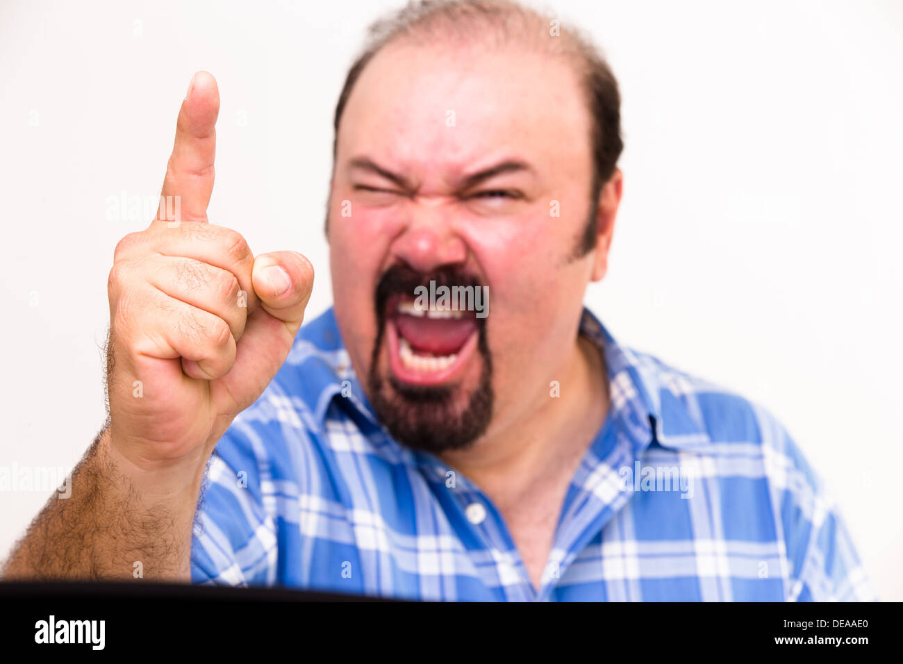 Horizontal portrait of an angry middle-aged Caucasian man screaming and threatening, isolated on white background Stock Photo
