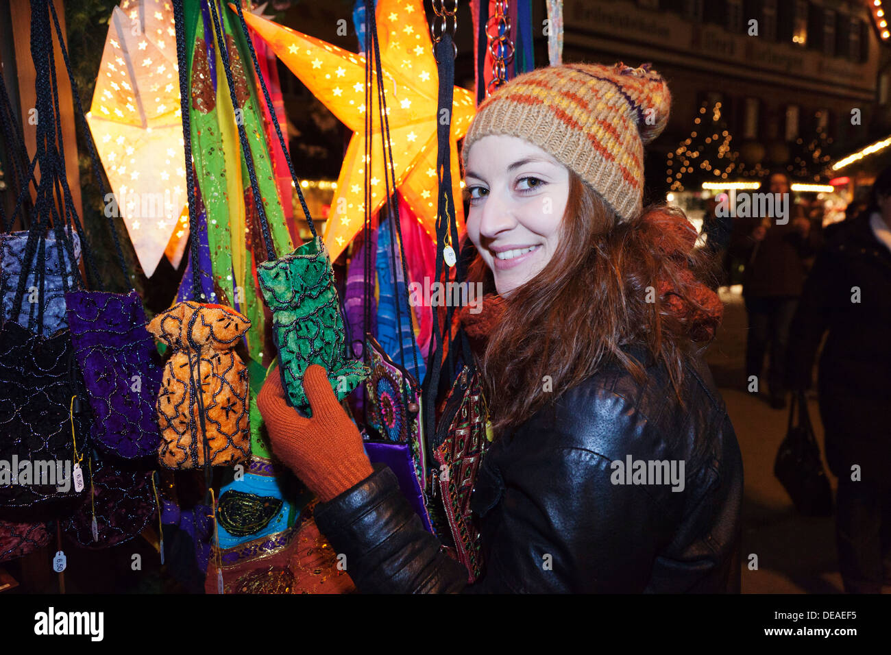 Young woman shopping at  Christmas fair, Esslingen, Baden Wurttemberg, Germany Stock Photo