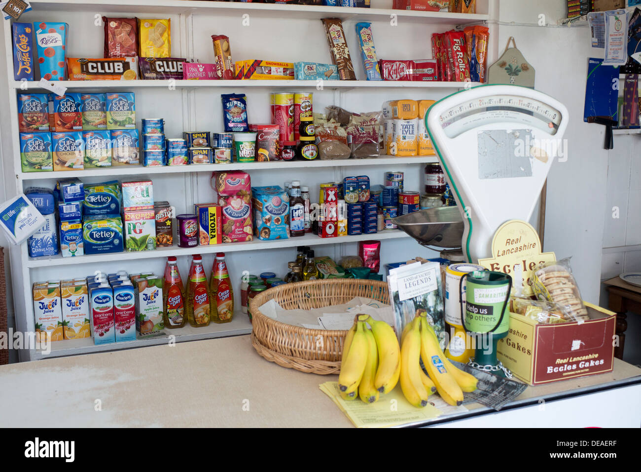 Interior of traditional corner shop with goods on shelves, counter
