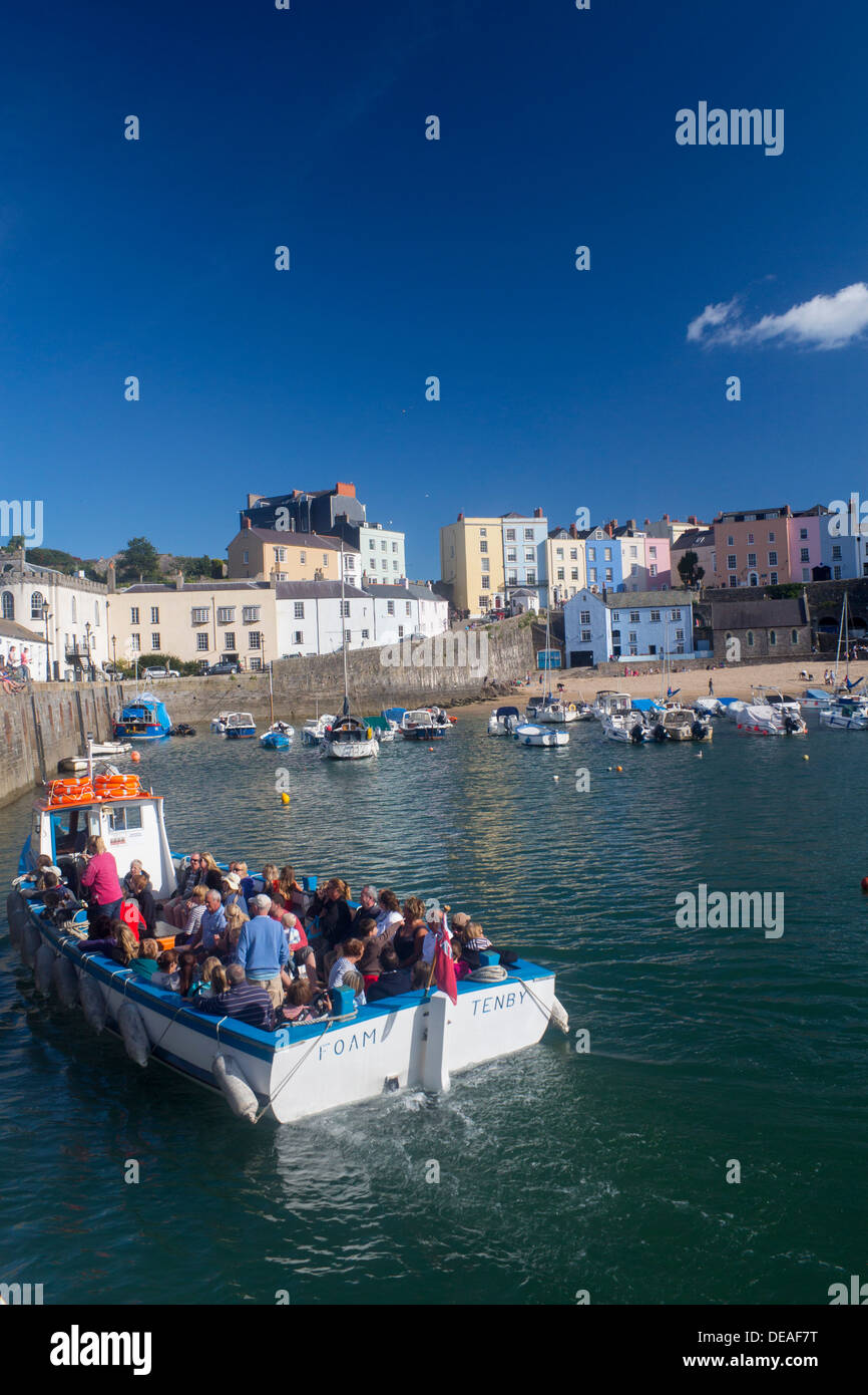People returning from boat trip arriving back at Tenby Harbour Tenby Pembrokeshire West Wales UK Stock Photo