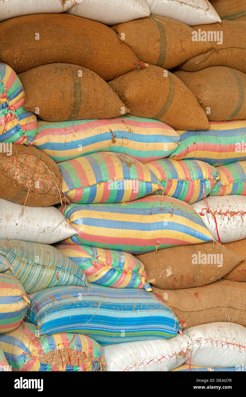 Plump bags of rice stacked in a rice warehouse, Battambang, Cambodia
