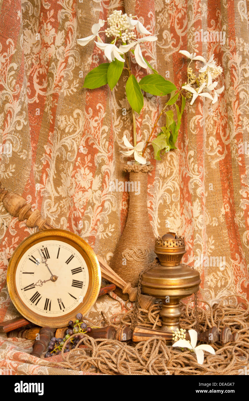 time concept still life with antique clock, old oil lamp and white