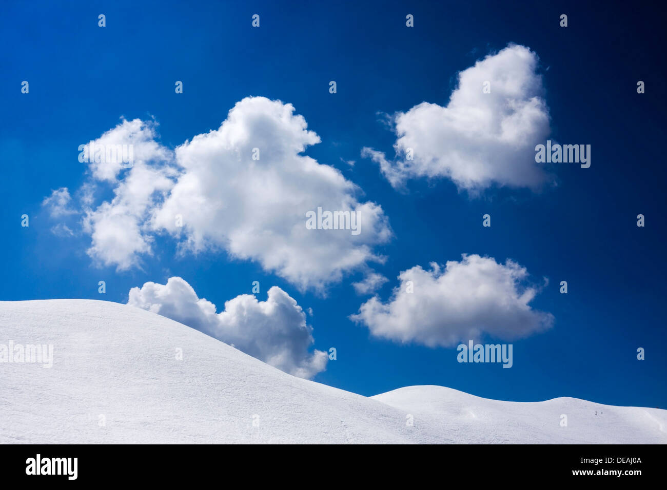 White clouds in blue sky, ridge of Creste de Zonia above Passo Giau or Giau Pass, Dolomites, Italy, Europe Stock Photo