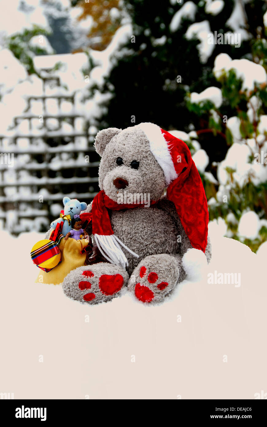 A Teddy Bear Santa Claus in the snow. Stock Photo