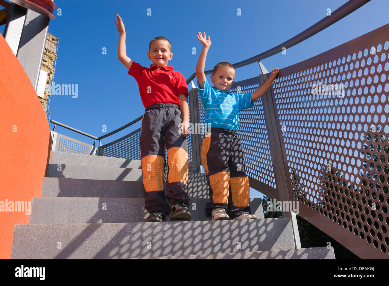 Boys, 6 and 4 years, on a staircase Stock Photo