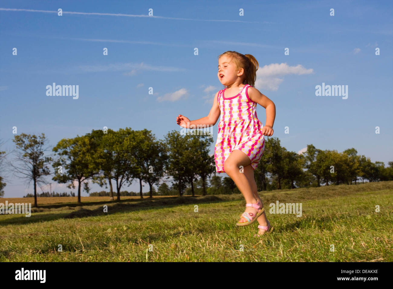 Running little girl, 3 years Stock Photo