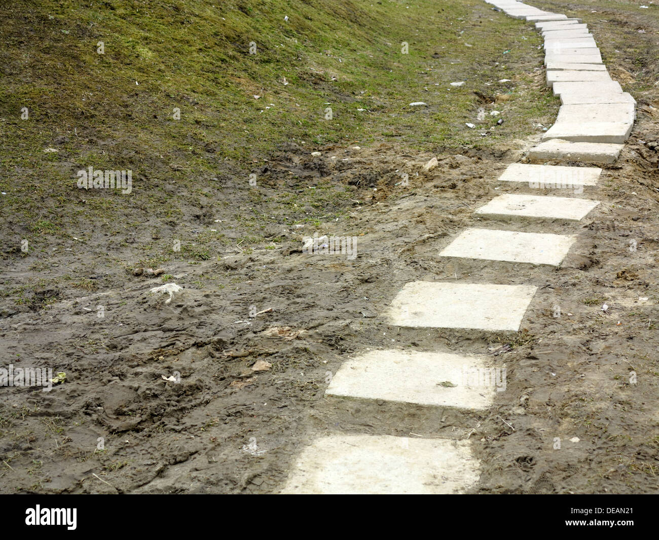 Stone path trail climbing through a muddy dirty park, brick sidewalk ...