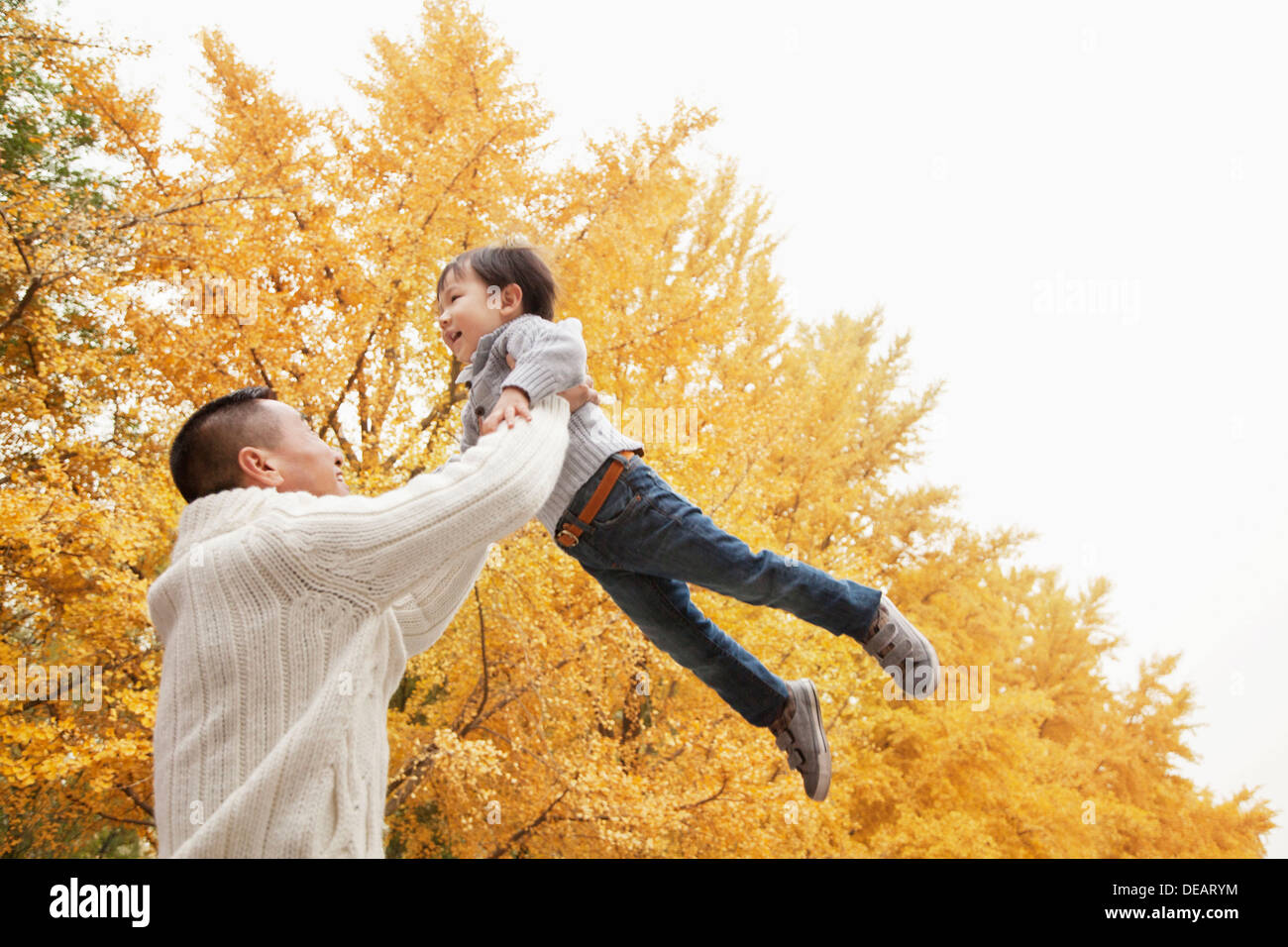 Father And Son Playing a Park in Autumn Stock Photo - Alamy