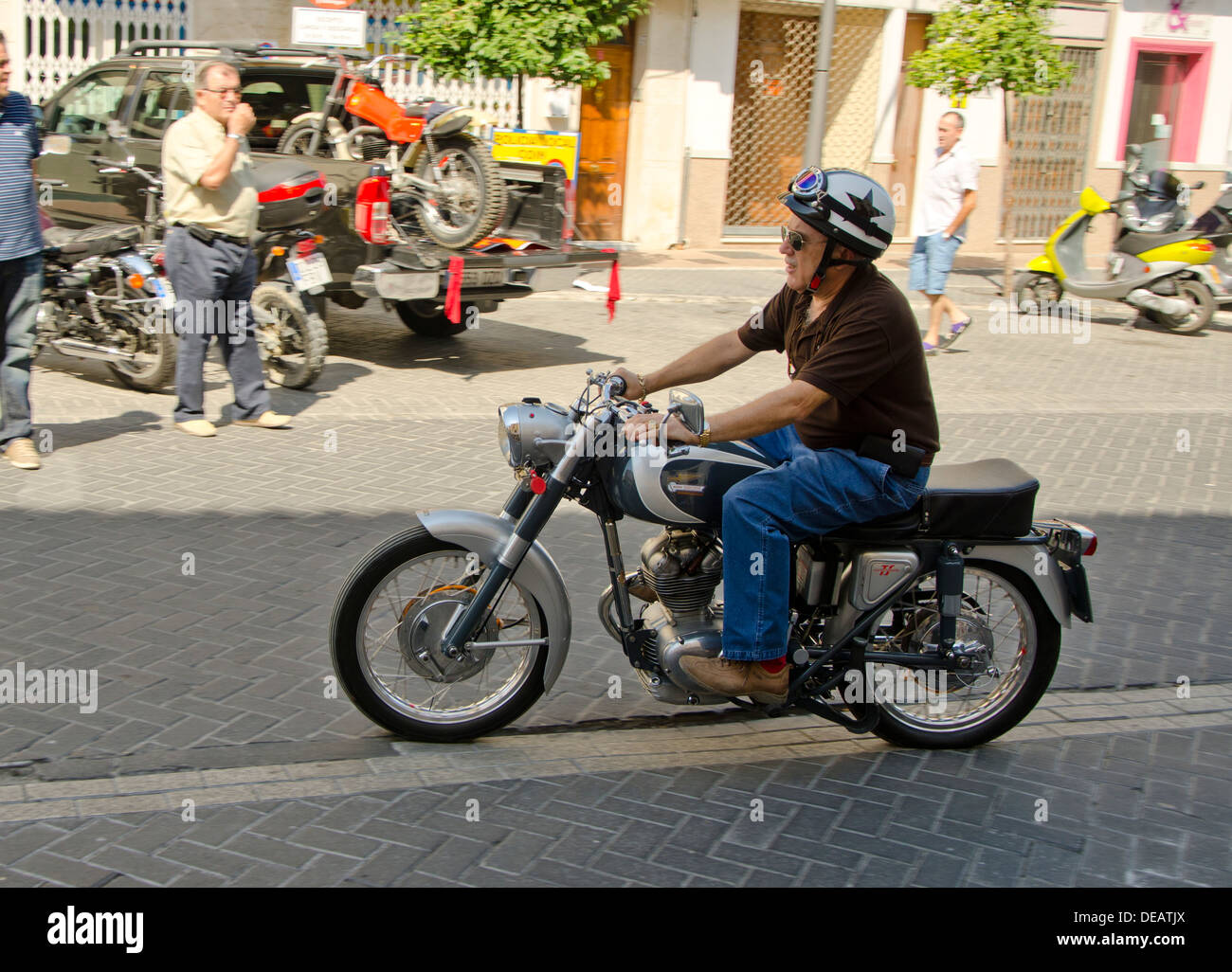 Man riding a Ducati 160 ts classic motorcycle at a vintage motorbike meeting in Coin Andalusia, Spain. Stock Photo