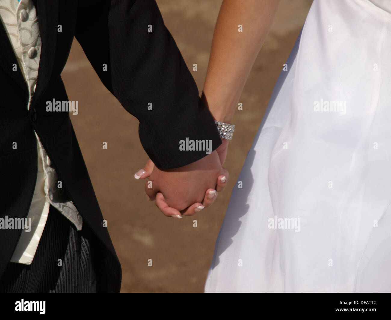 Newly weds holding hands, UK 2013 Stock Photo