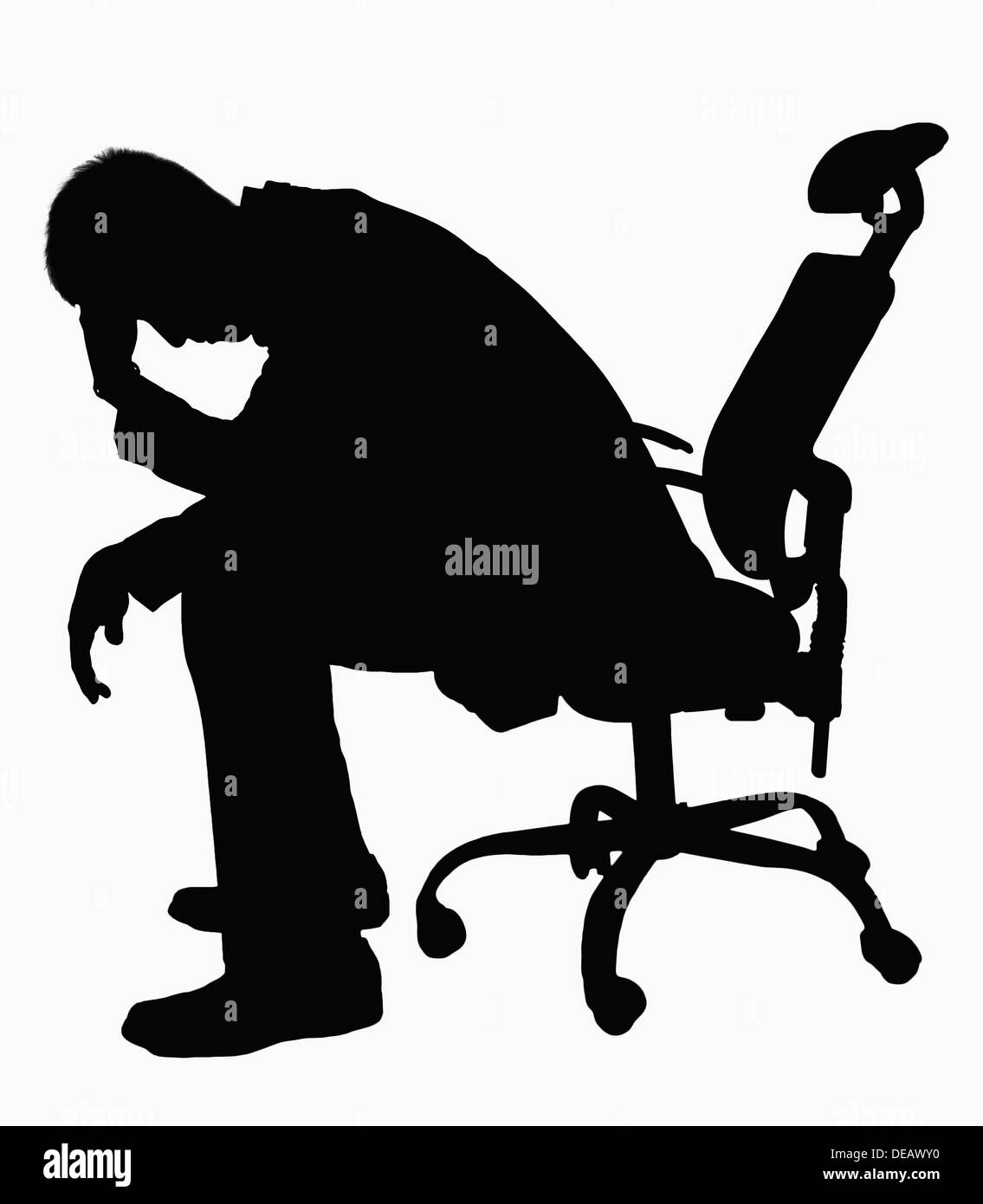 Silhouette of businessman sitting with hand on his head. Stock Photo