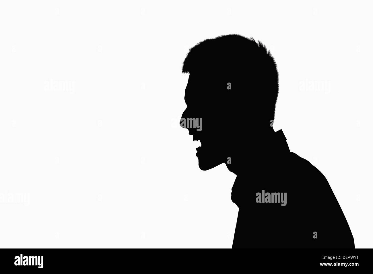Silhouette of man screaming. Stock Photo