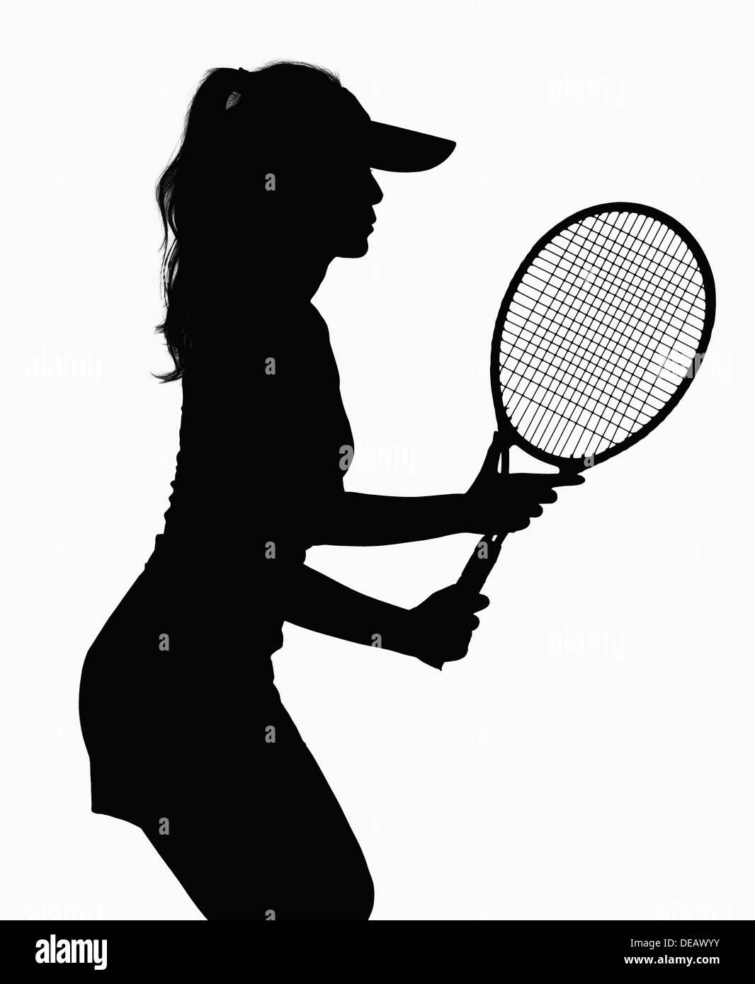 Silhouette of woman with tennis racket. Stock Photo