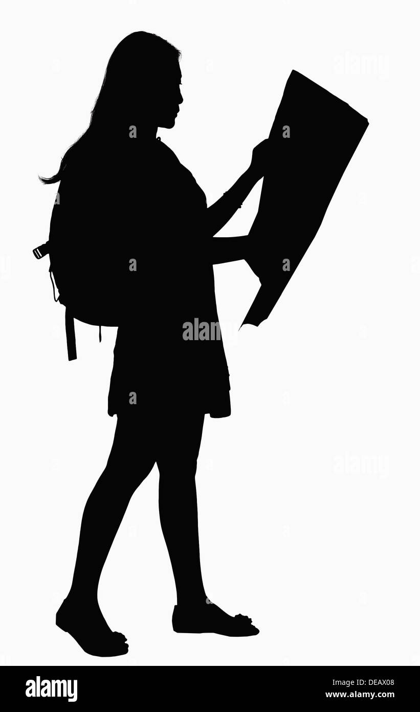 Silhouette of woman looking at map. Stock Photo