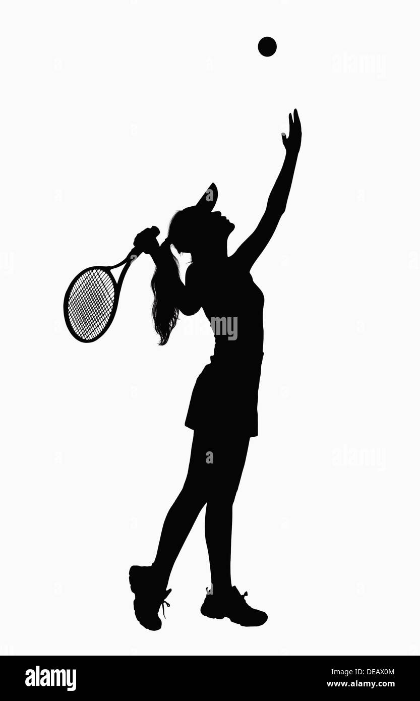 Silhouette of woman with tennis racket, serving. Stock Photo