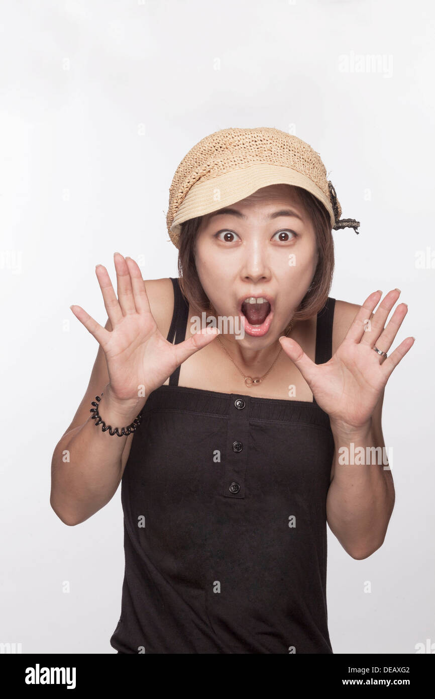 Portrait of surprised woman with hands raised, studio shot Stock Photo ...