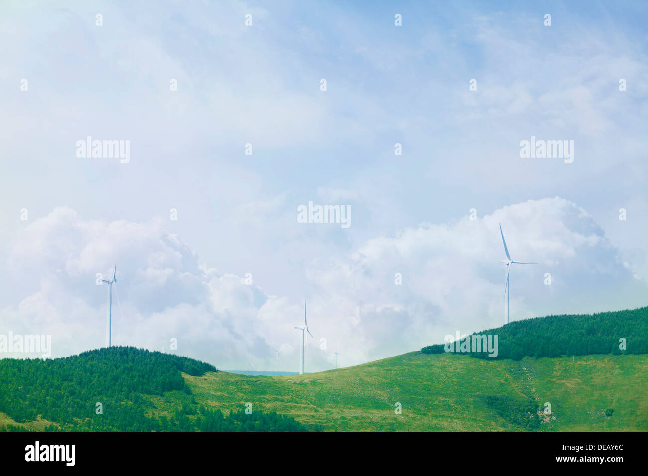 Wind turbines on lush, green, landscape with clouds Stock Photo - Alamy
