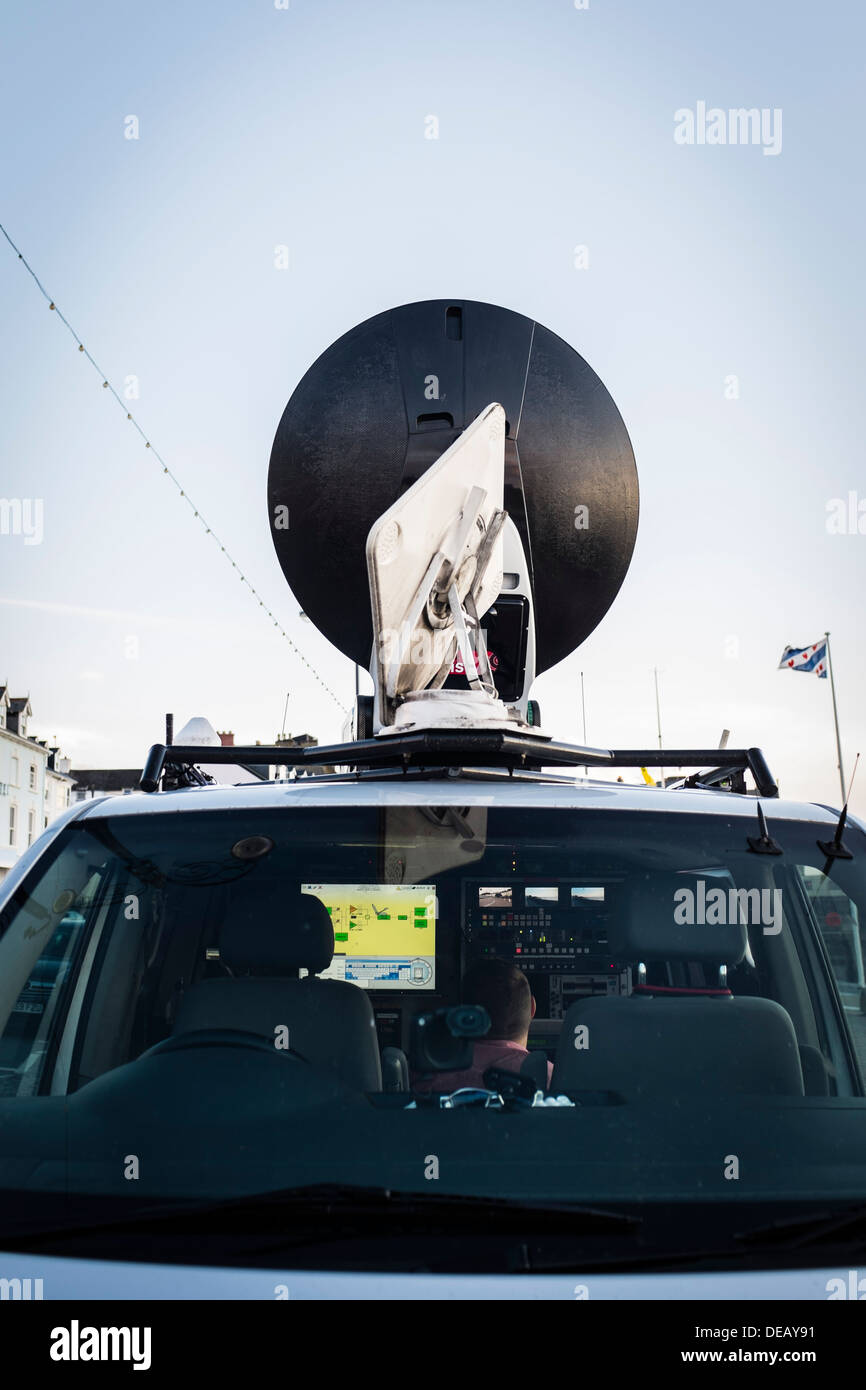 An engineer working in the transmission satellite truck for BBC Wales television news crew doing a live outside broadcast UK Stock Photo