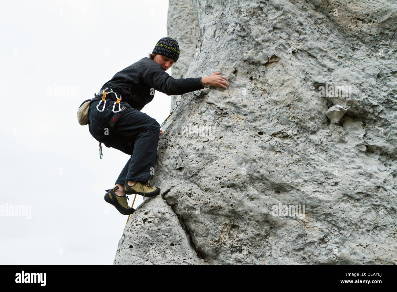 Rock climber leading a difficult climbing route on limestone rock Stock