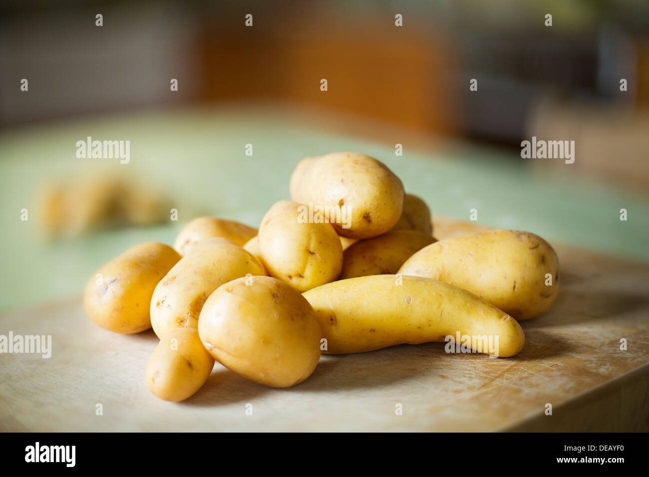 Potatoes on a chopping board Stock Photo