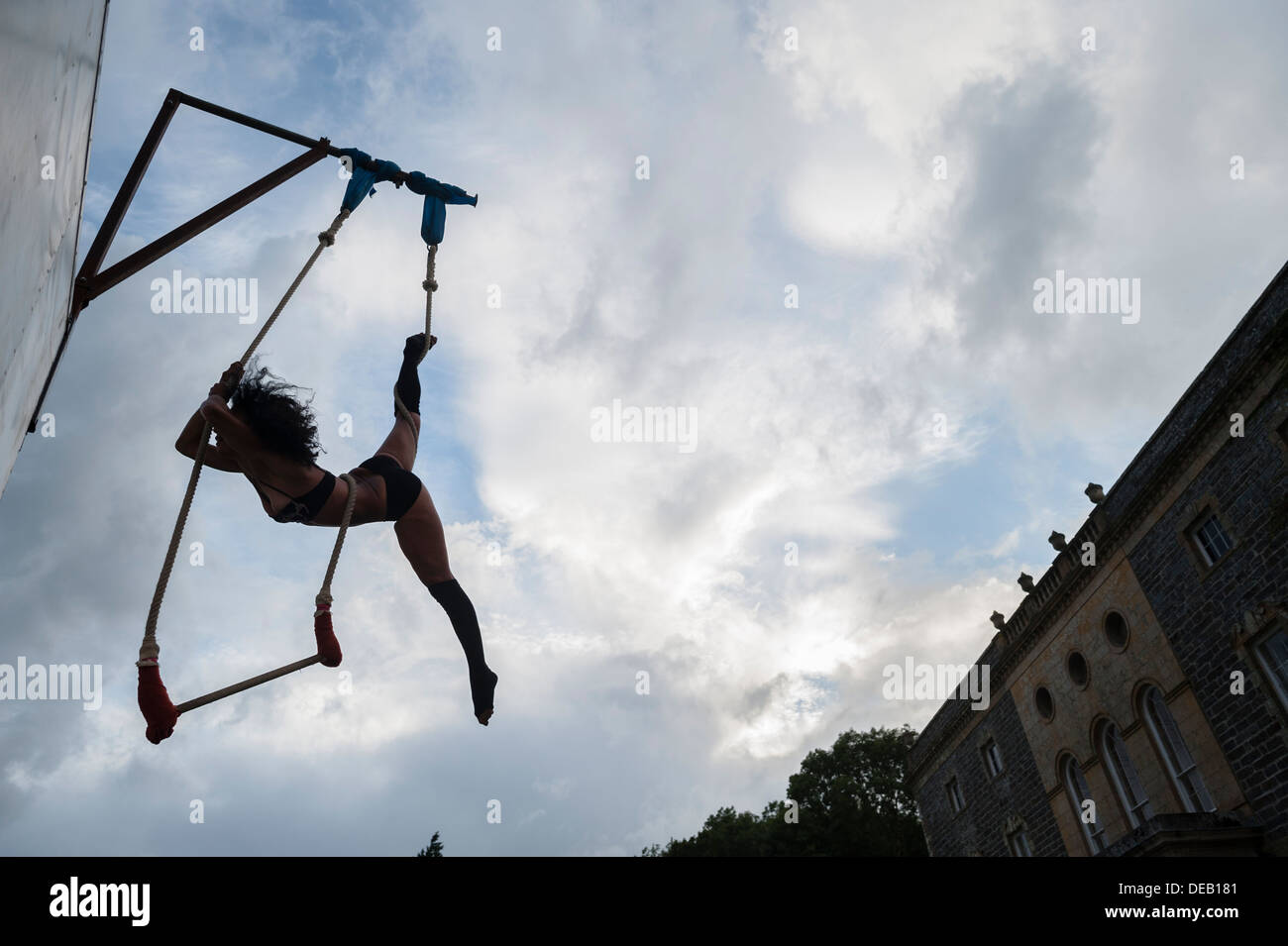 The silhouette of a woman trapeze artist entertainer at a summer party at a country house hotel UK Stock Photo