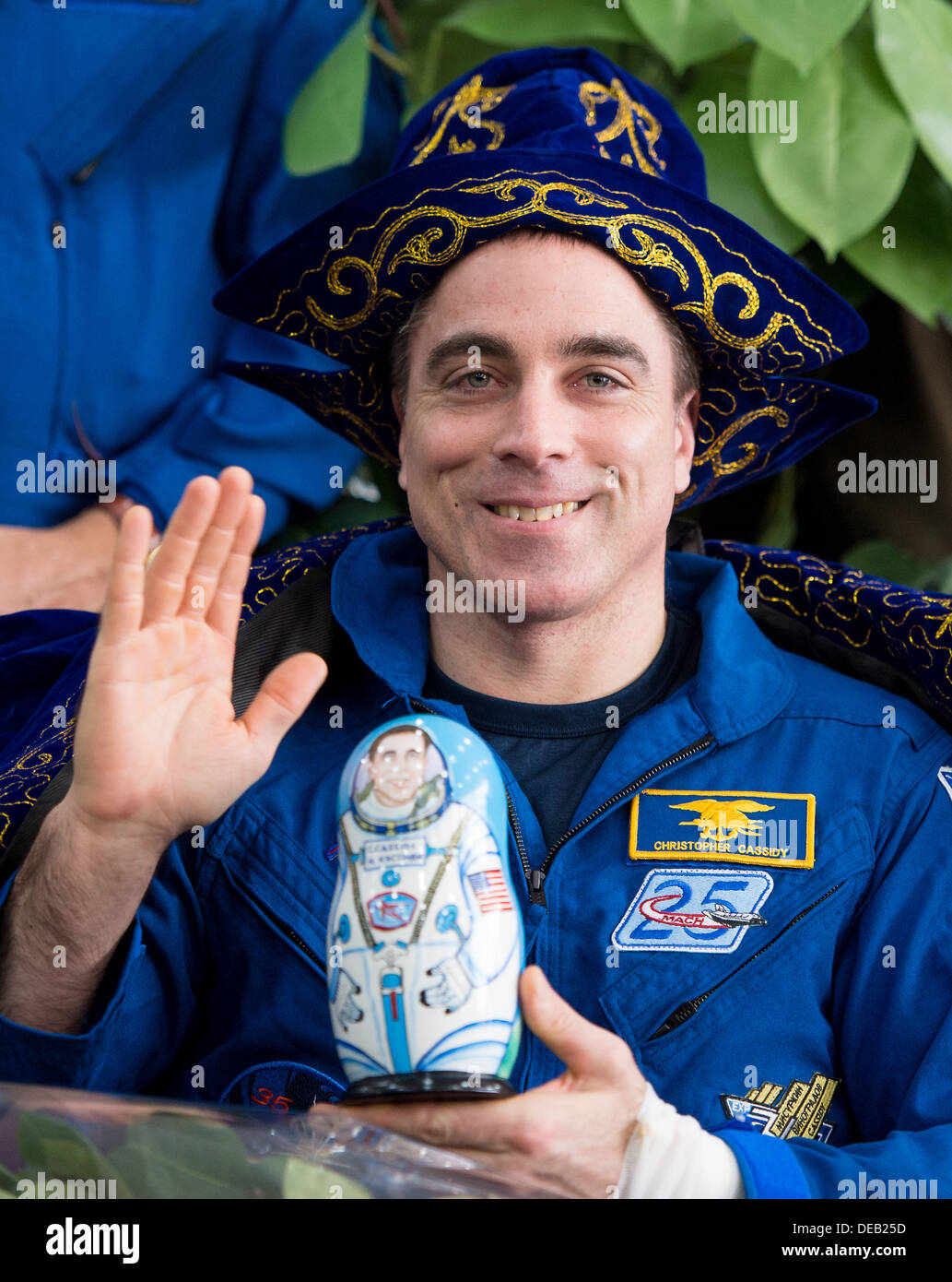NASA Expedition 36 Flight Engineer Chris Cassidy waves during a ceremony at the Karaganda airport after he and Alexander Misurkin and Pavel Vinogradov of Roscosmos landed in a Soyuz TMA-08M capsule September 11, 2013 in Karaganda, Kazakhstan. Vinogradov, Misurkin and Cassidy returned to Earth after five and a half months on the International Space Station. Stock Photo