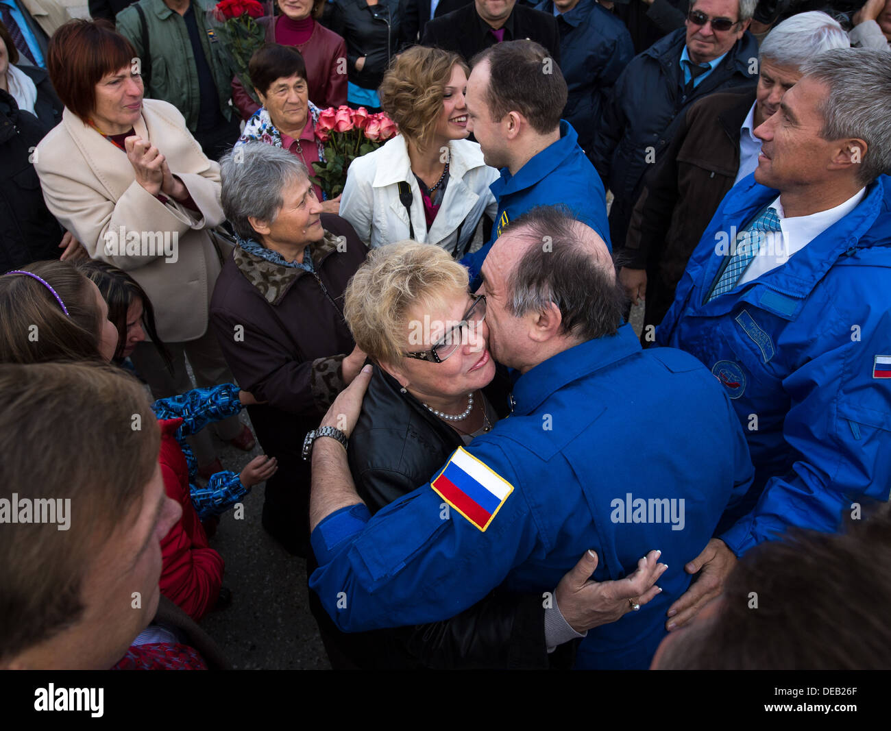 Roscosmos Expedition 36 Commander Pavel Vinogradov, bottom left, and Flight Engineer Alexander Misurkin of Roscosmos are welcomed by family, friends and colleagues at the Chkalovsky airport several hours after landing in a Soyuz TMA-08M capsule September 11, 2013 Star City, Russia. Vinogradov, Misurkin and Cassidy returned to Earth after five and a half months on the International Space Station. Stock Photo