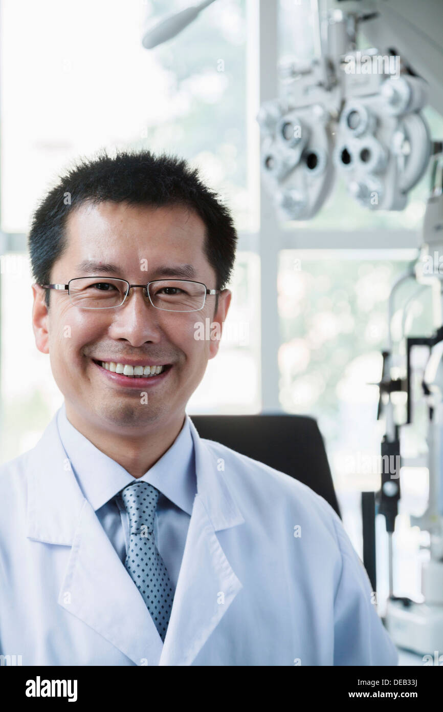 Portrait of smiling optometrist in his clinic Stock Photo