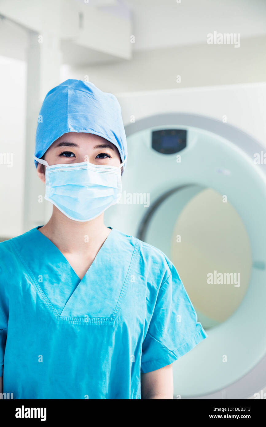 Portrait of young female surgeon wearing surgical mask in the operating ...