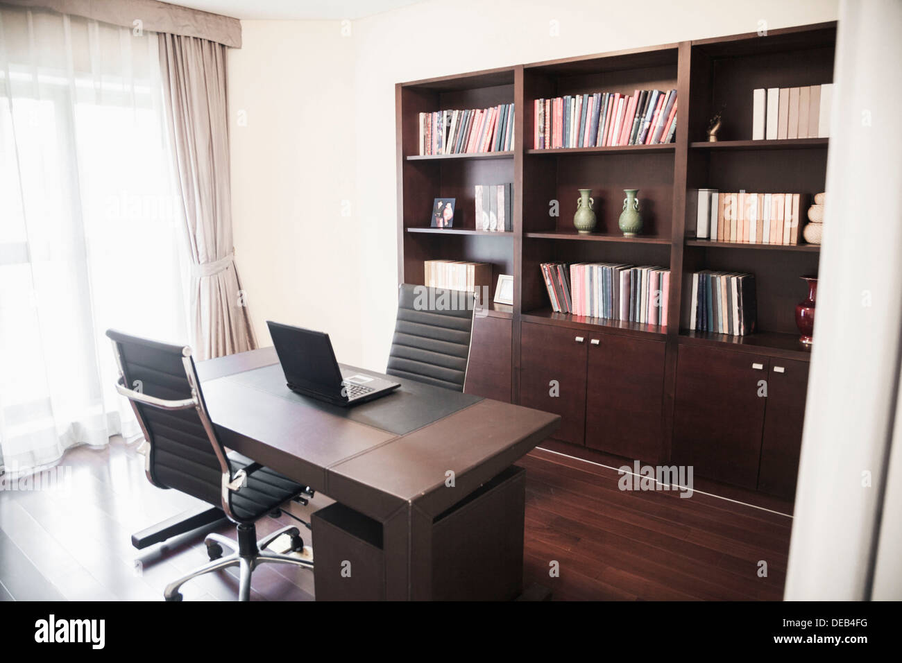 Modern home office with bookshelves. Stock Photo