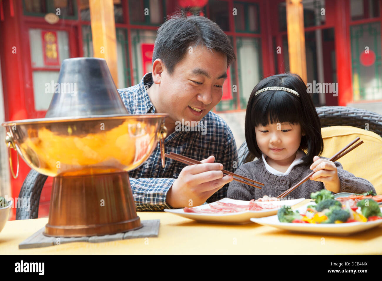 Father and daughter eating Chinese food outside Stock Photo Alamy