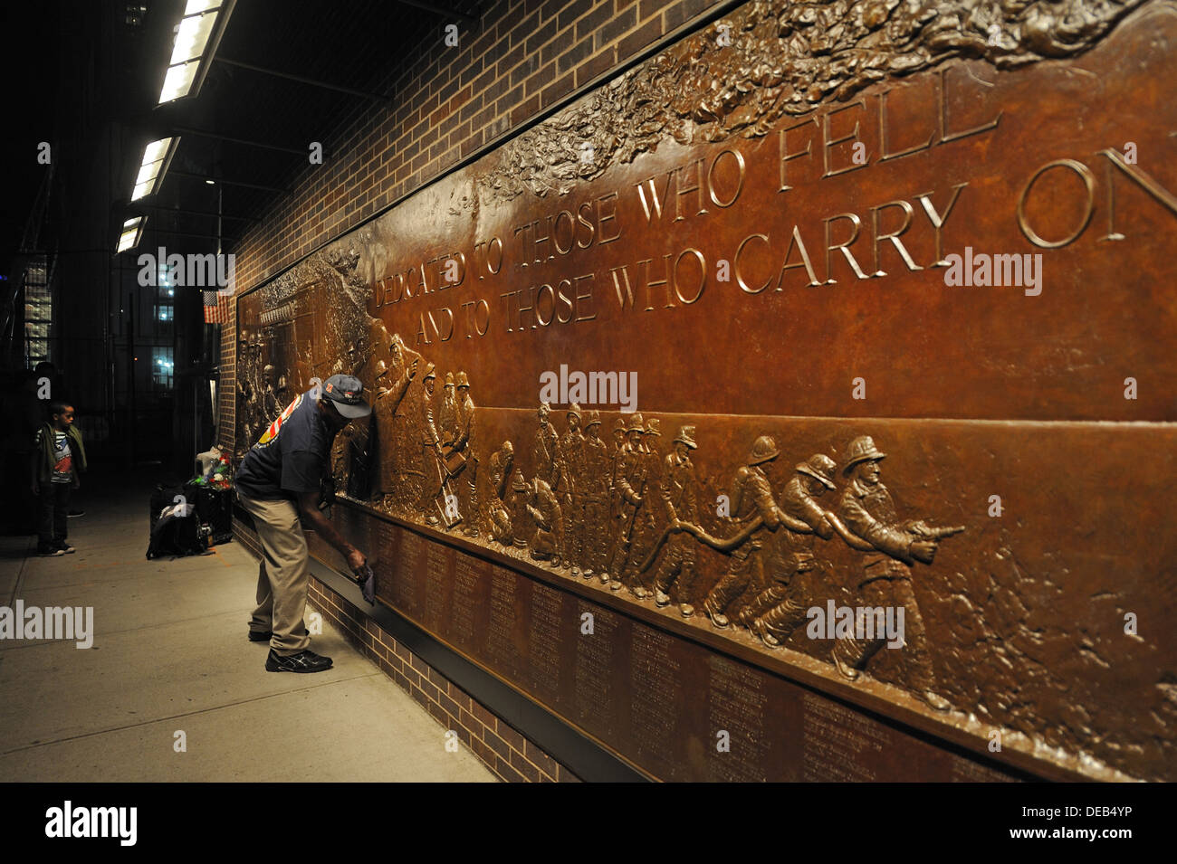 A man polished the names on a memorial near the World Trade Center in Manhattan for the firefighters who died on Sept. 11, 2001. Stock Photo