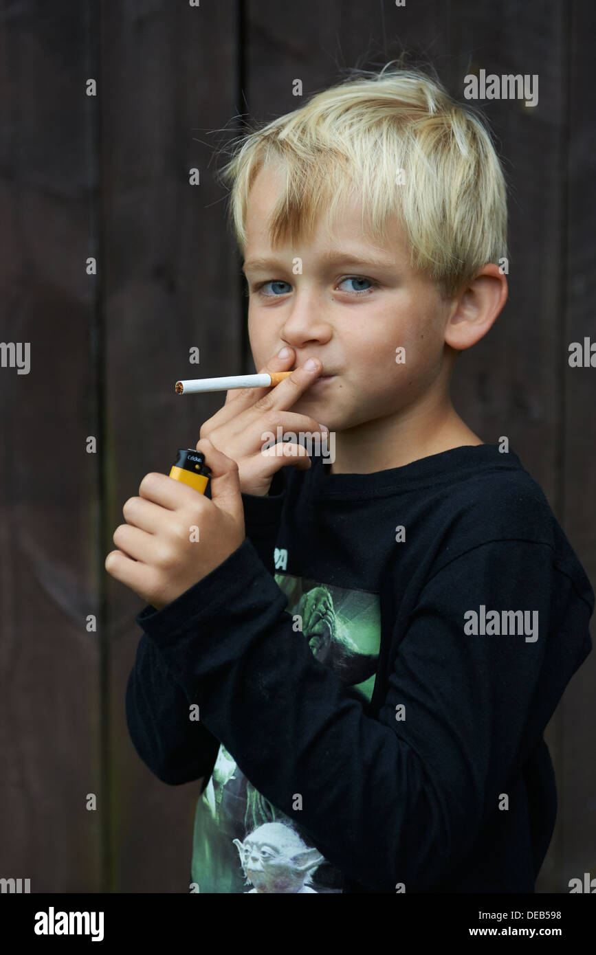Child blond boy smoking cigarette Stock Photo