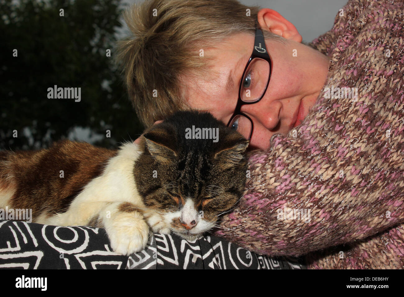 Tabby cat and woman in knitted jumper Stock Photo