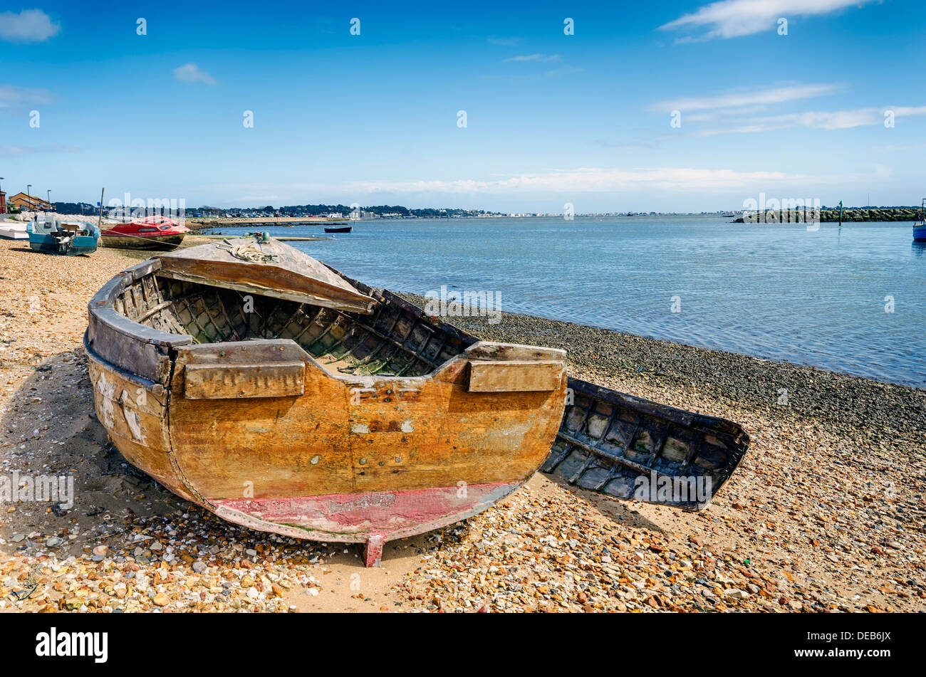 An old wrecked wooden boat on the shore at Poole in Dorset Stock Photo