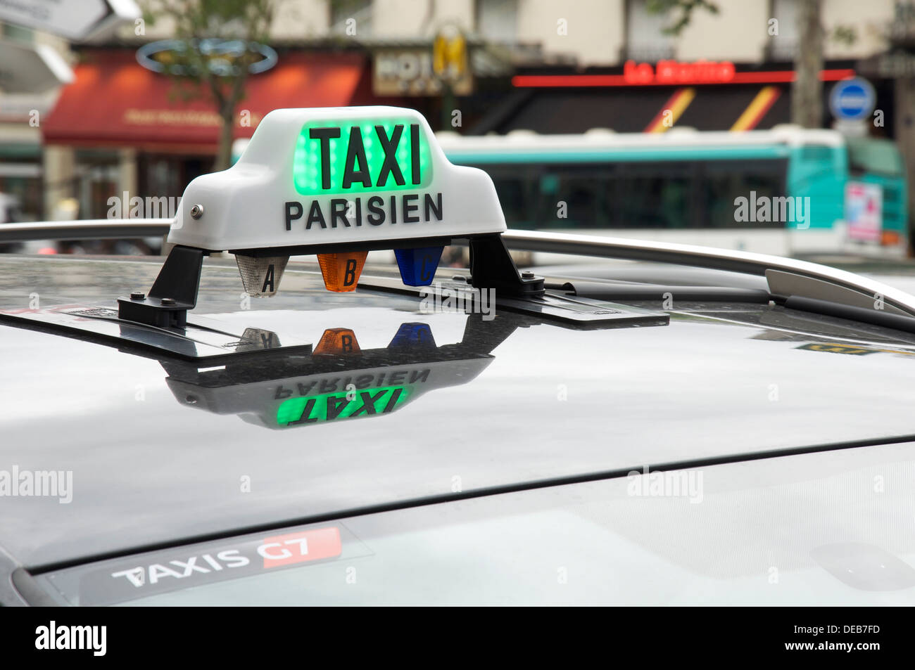 French public transport. The illuminated roof sign of a Parisian taxi cab, waiting for its next fare. Paris, France. Stock Photo