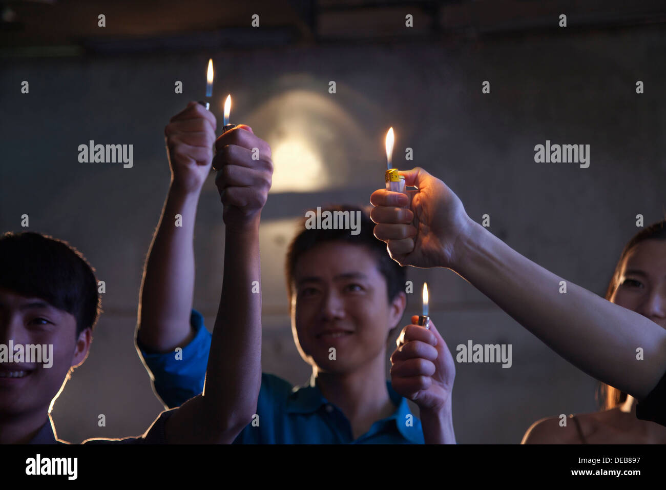 Group of people holding cigarette lighters at a concert Stock Photo Alamy