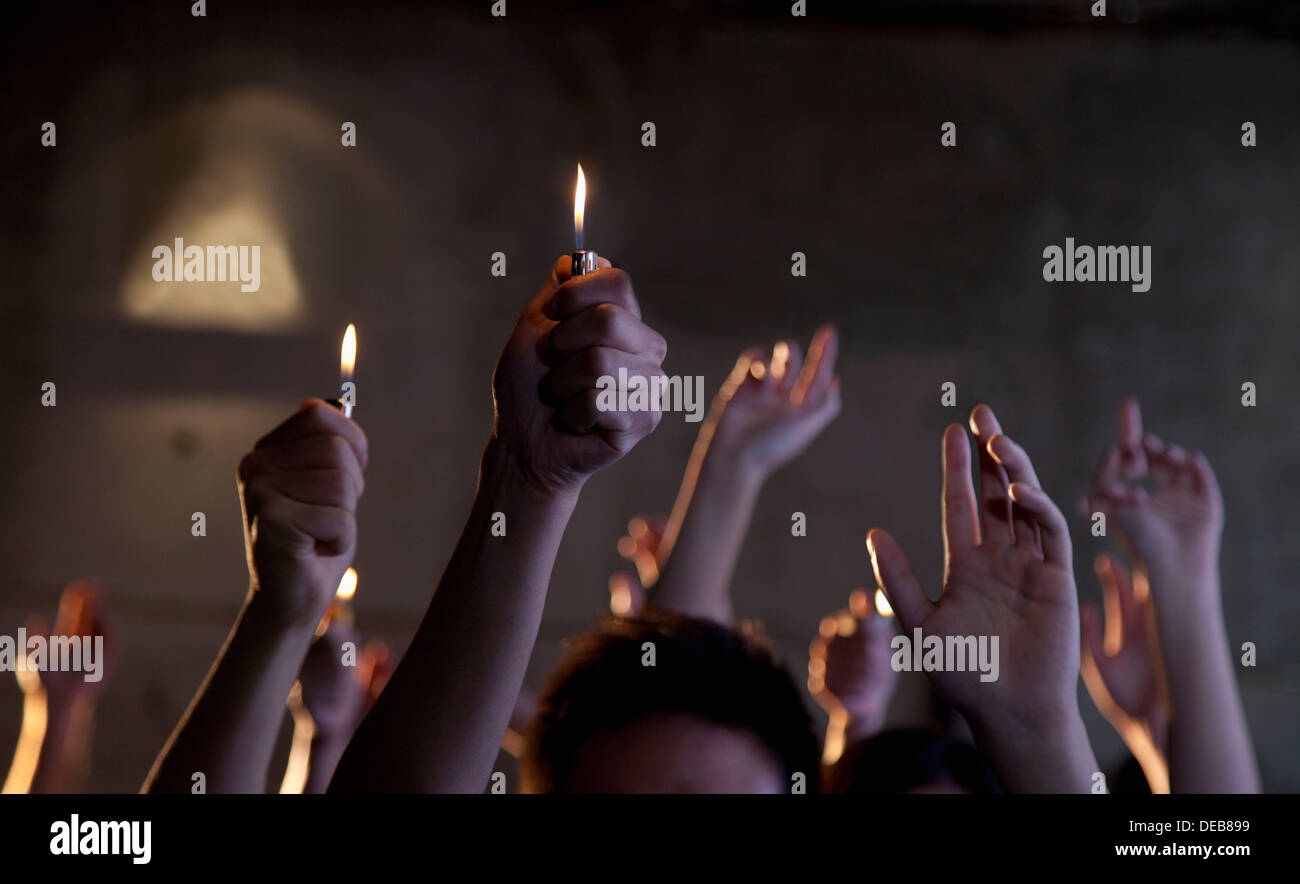 Group of people holding cigarette lighters at a concert Stock Photo Alamy