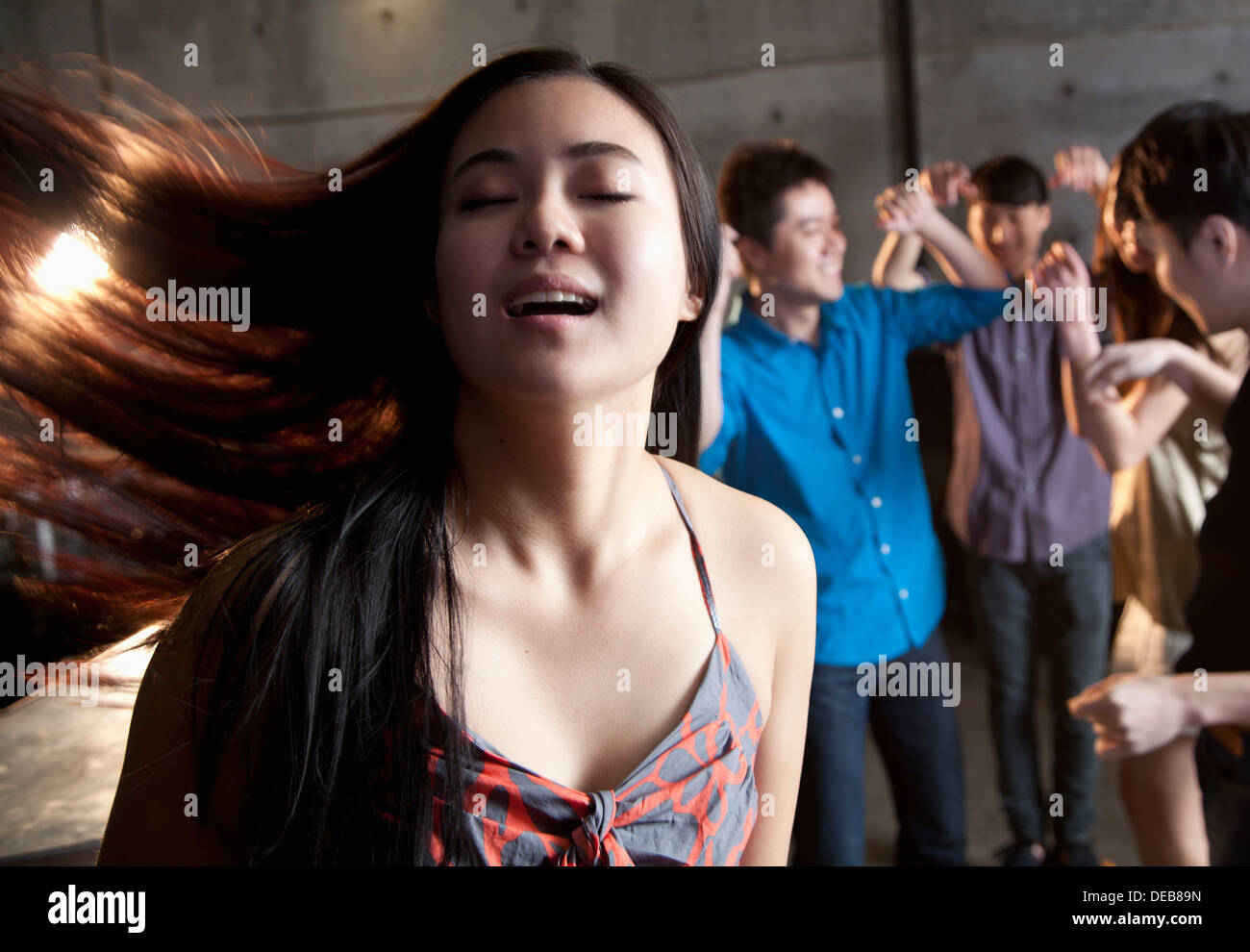 Young woman dancing with her eyes closed Stock Photo Alamy