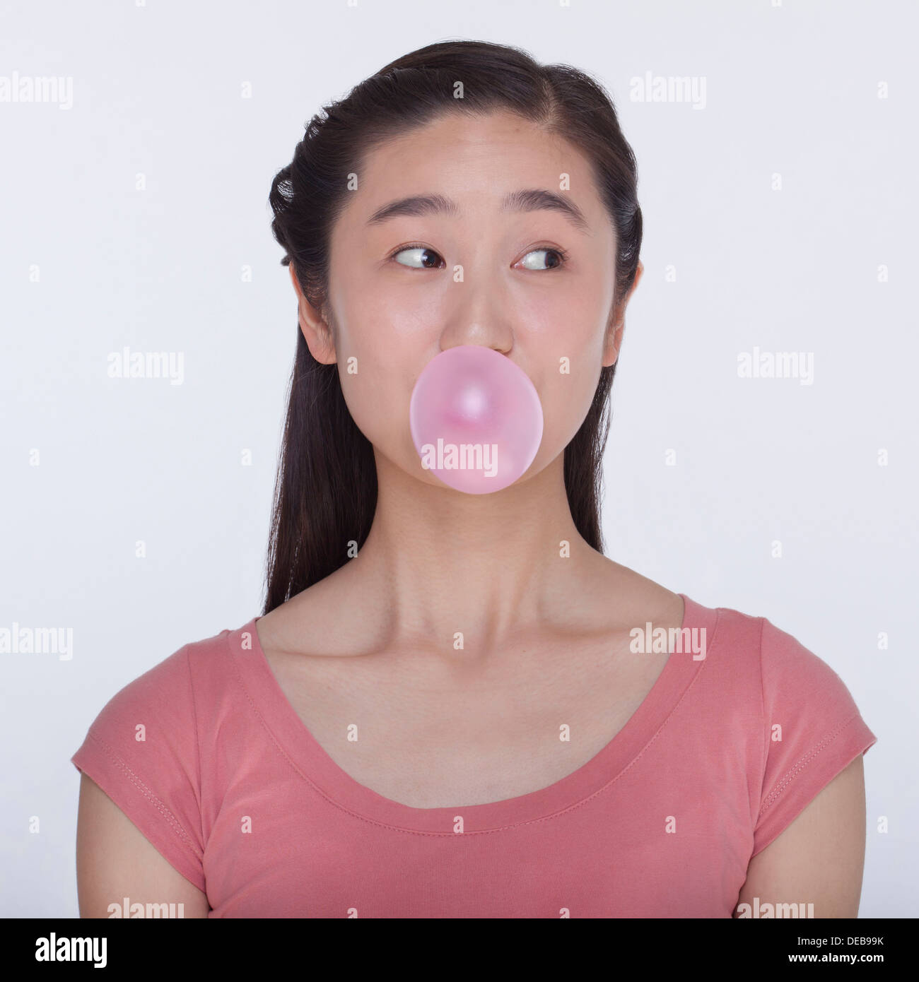 Young playful woman blowing a bubble