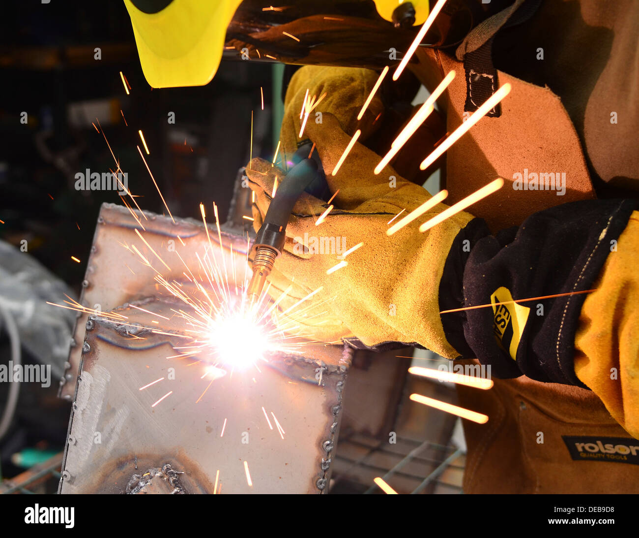 Welder mig welding a sculpture using flux core wire Stock Photo