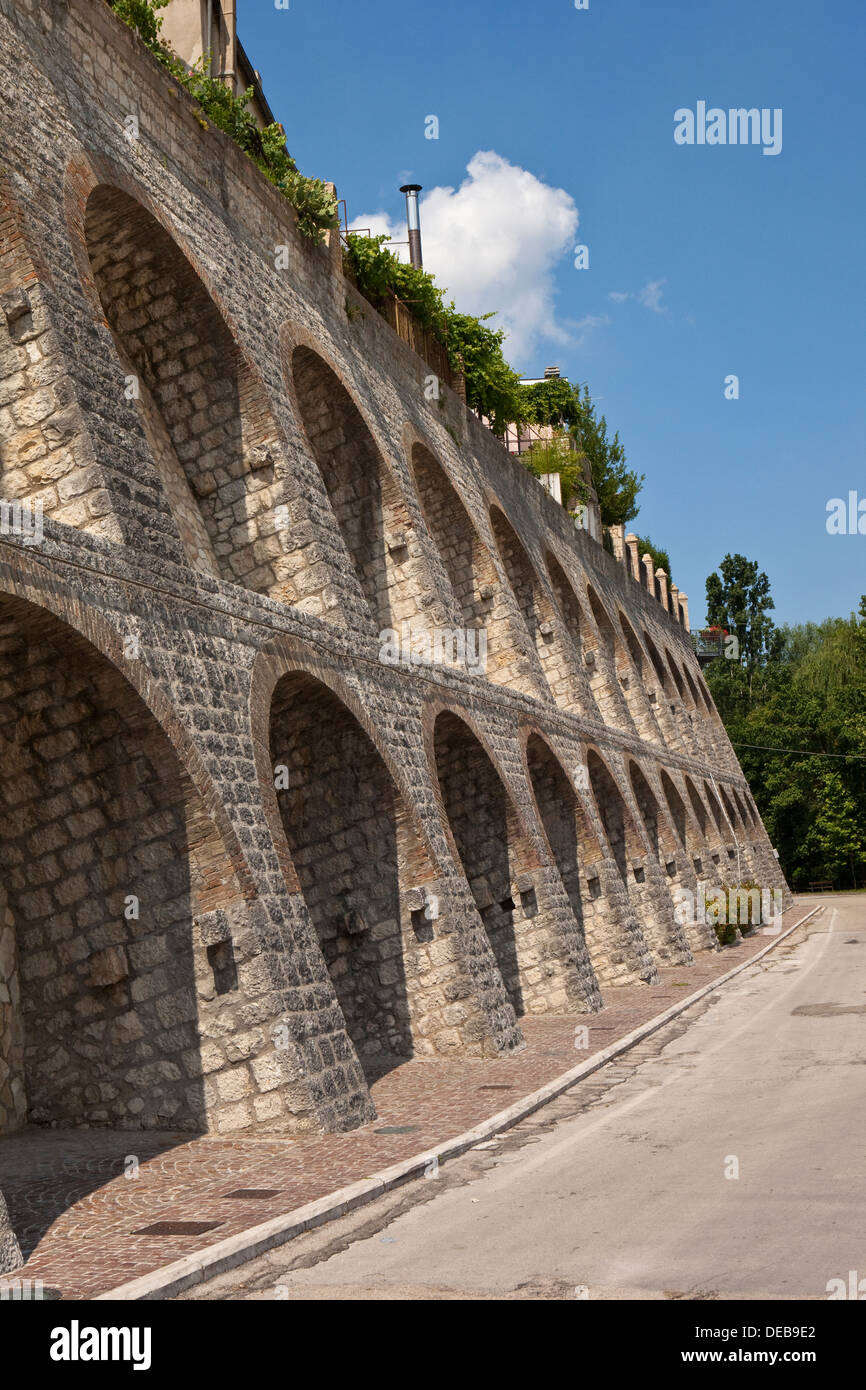 Italian hill town wall showing reinforcement arches Stock Photo