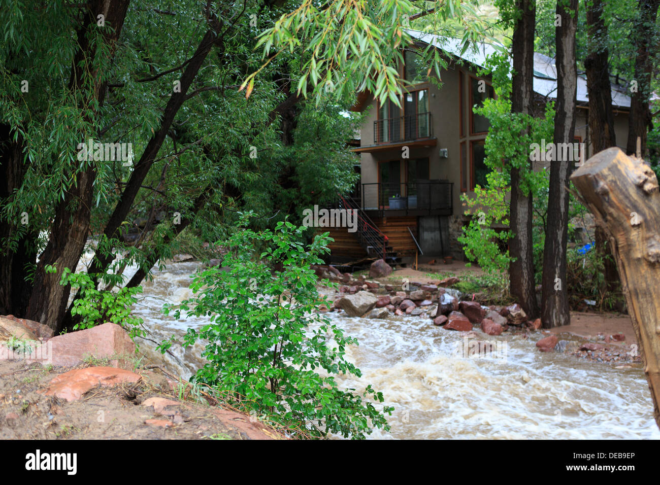 Boulder, CO. 15th September 2013 - A home in Eldorado Springs is threatened by a rain swollen creek in Eldorado Canyon.  The final wave of rain storms make their way through Boulder, Colorado bringing another day of flooding to the rain swollen area. © Ed Endicott / Alamy Live News Stock Photo