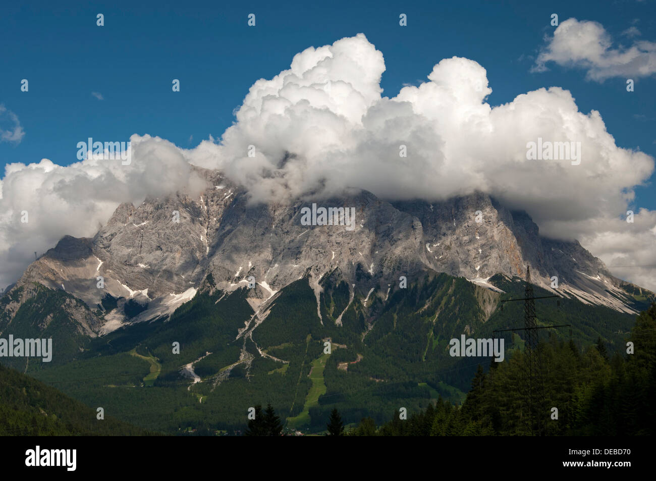 Cumulus clouds looming over a mountain ridge, Ehrwald, Tyrol, Austria Stock Photo