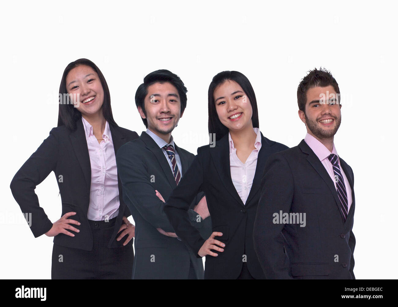 Portrait of four young business people looking at the camera, three quarter length, studio shot Stock Photo