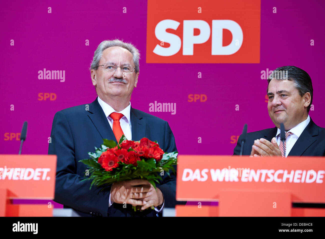 Berlin, Germany. September 16th, 2013. Sigmar Gabriel (SPD) and Christian Ude (SPD), the SPD top candidate in Bavaria gave their statements about the election results a day after the state elections in Bavaria. / Picture: Christian Ude (SPD), Mayor of Munich, recieves flowers from ga in Berlin after the Bavaria elections. Credit:  Reynaldo Chaib Paganelli/Alamy Live News Stock Photo